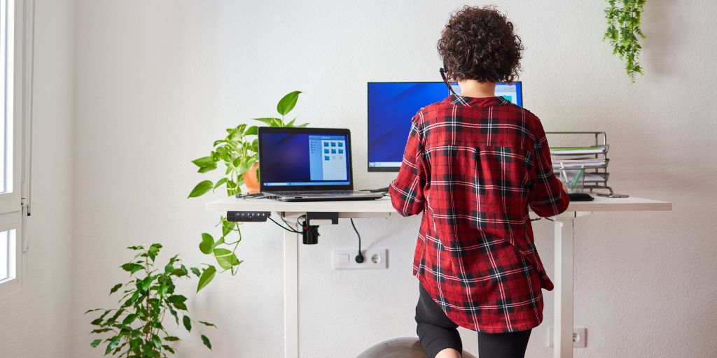 lady working at a stand up desk at home