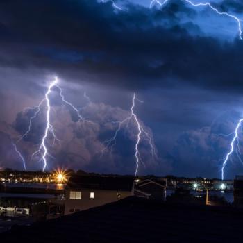 Lightning strikes over neighborhood
