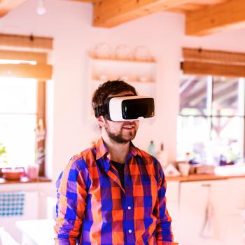 Man standing in living room with virtual reality headset on