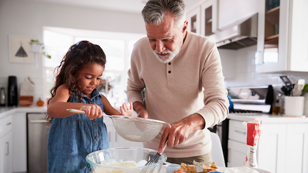 Grandfather baking with his granddaughter